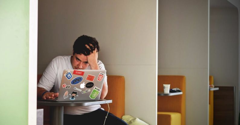 Programs - Man in White Shirt Using Macbook Pro