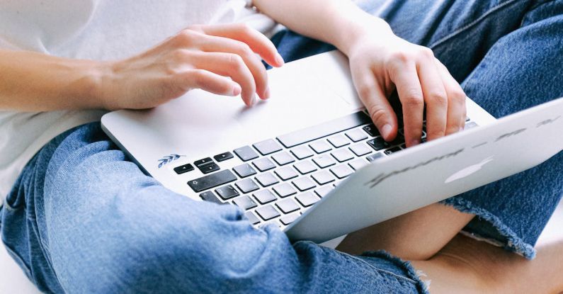 Programs - Person in Blue Denim Jeans Using Macbook