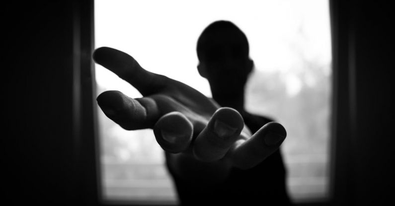 Help - Man's Hand in Shallow Focus and Grayscale Photography