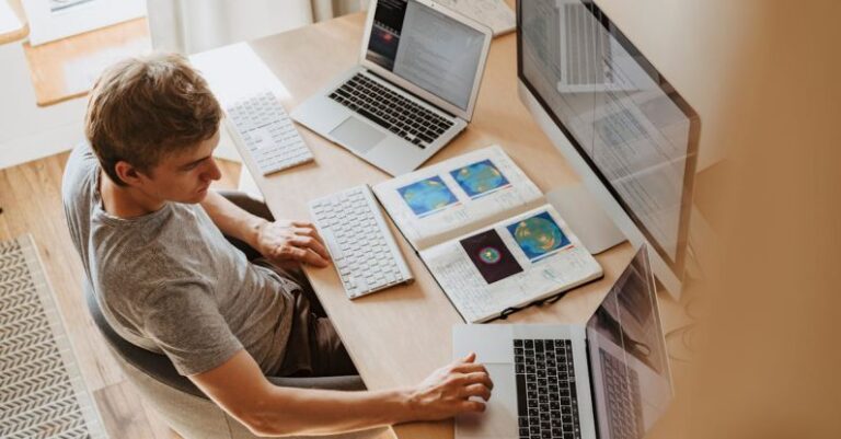 Programs - Man Using 3 Computers