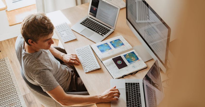 Programs - Man Using 3 Computers